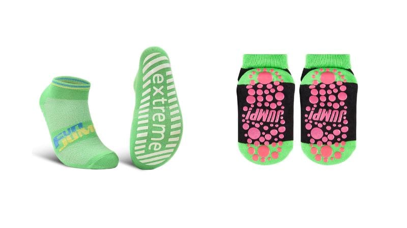 Two pairs of green trampoline socks: one with "extreme" on the sole, the other dotted with "JUMP!" Stay stylish and comfy while exercising.