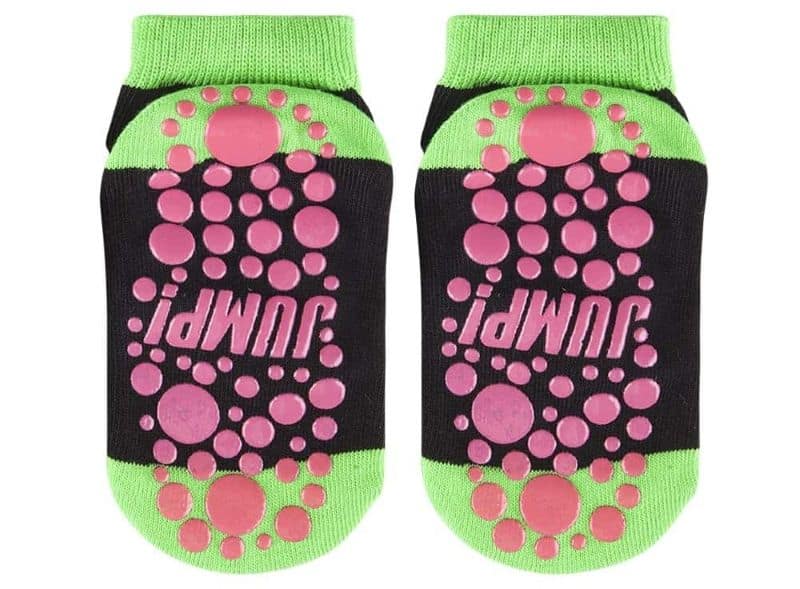 Black and green grip socks with pink rubber dots and "JUMP!" text on the soles for extra traction during activity.