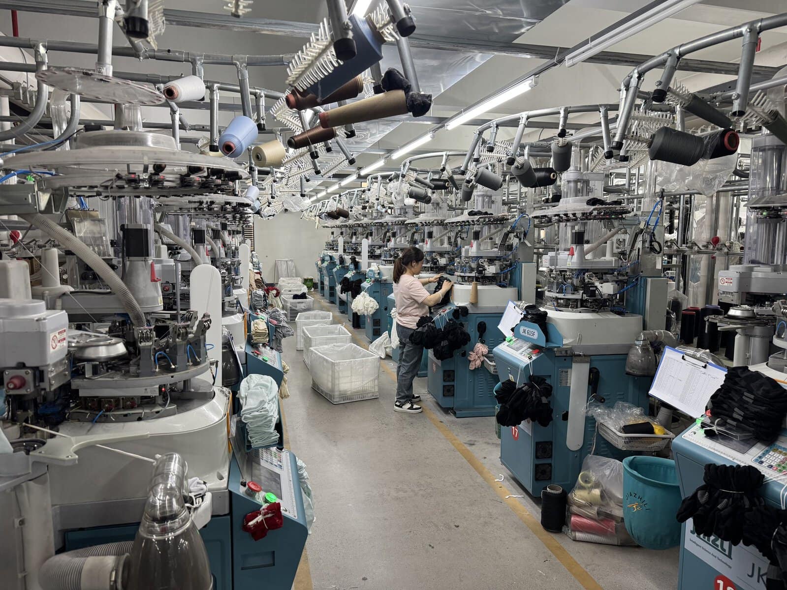 Sock knitting workshop floor at SinoKnit factory with rows of knitting machines